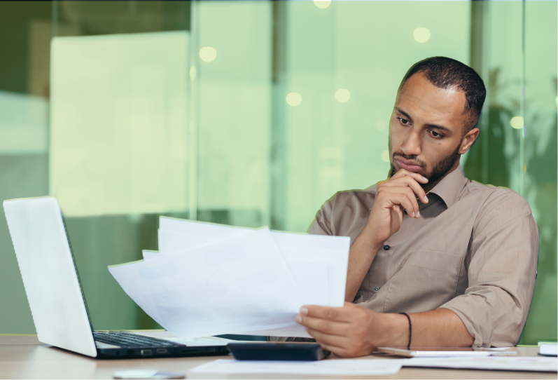 An employee is reviewing their termination notice while sitting at their desk.