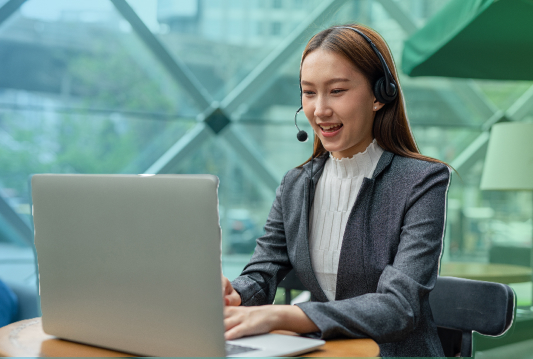 An employee is working in a hybrid working arrangement on their laptop in a remote location.