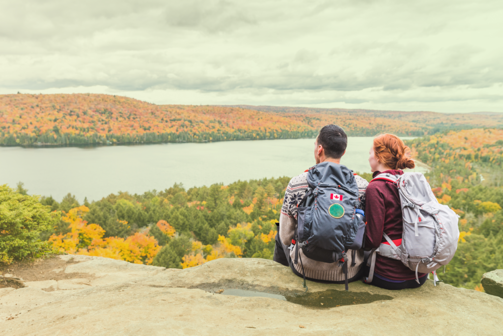 Statutory Holidays in Ontario are being enjoyed by two people who are looking at a scenic lake.