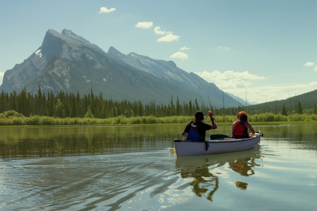 People enjoying General Holidays in Alberta 2025. Two people are canoeing on a lake