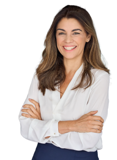 Woman smiling at camera with her arms crossed.