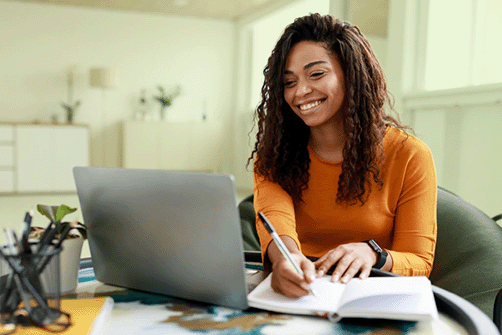 An HR employee is looking up an HR compliance guide on their laptop
