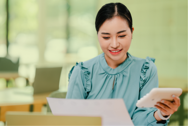 An employee has received a holiday shut down letter at her desk and is reading it.