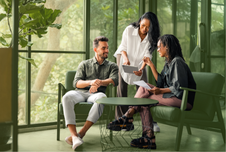 Three employees are sitting down discussing the Working For Workers Acts deadlines in 2025