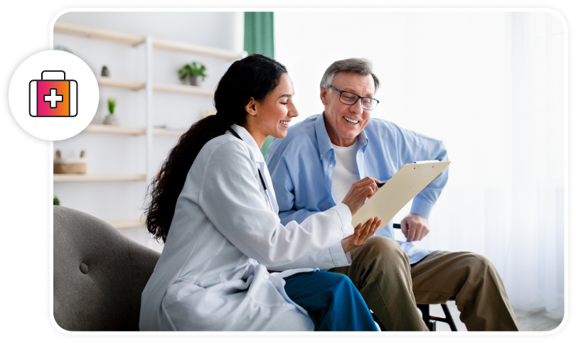 A healthcare professional and a patient are discussing what is on the clipboard the healthcare professional is holding while both smiling.