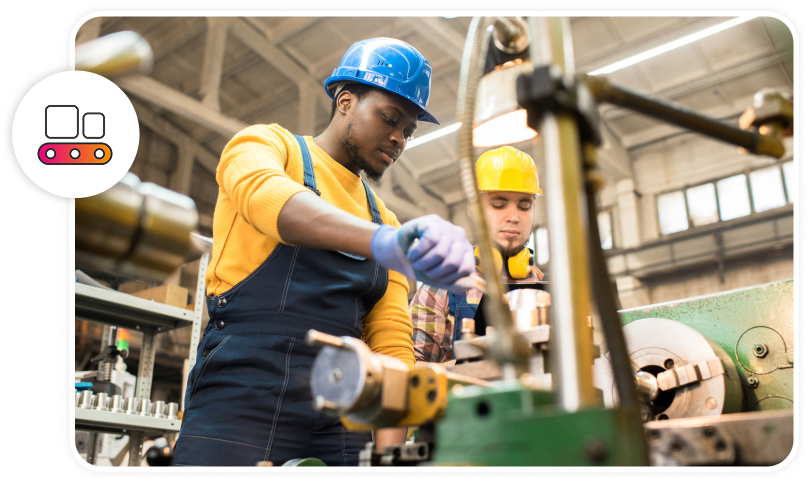A worker is using a piece of equipment in a manufacturing facility