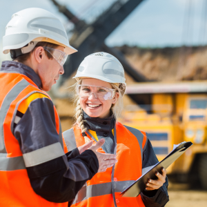 Two construction workers talking on mining site