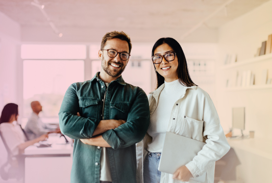 Two happy Citation Canada employees smiling, standing shoulder to shoulder