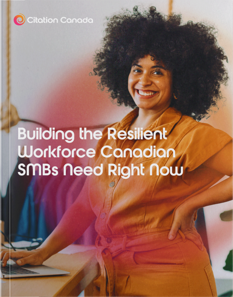 The cover page for the guide; Building the Resilient Workforce Canadian SMBs Need Right Now. An employee is standing next to their desk with their right hand on their laptop. They aare smiling. The Citation Canada pink-to-orange swirl logo is transparently wrapped around her and the title appears in white text in the middle of the image.